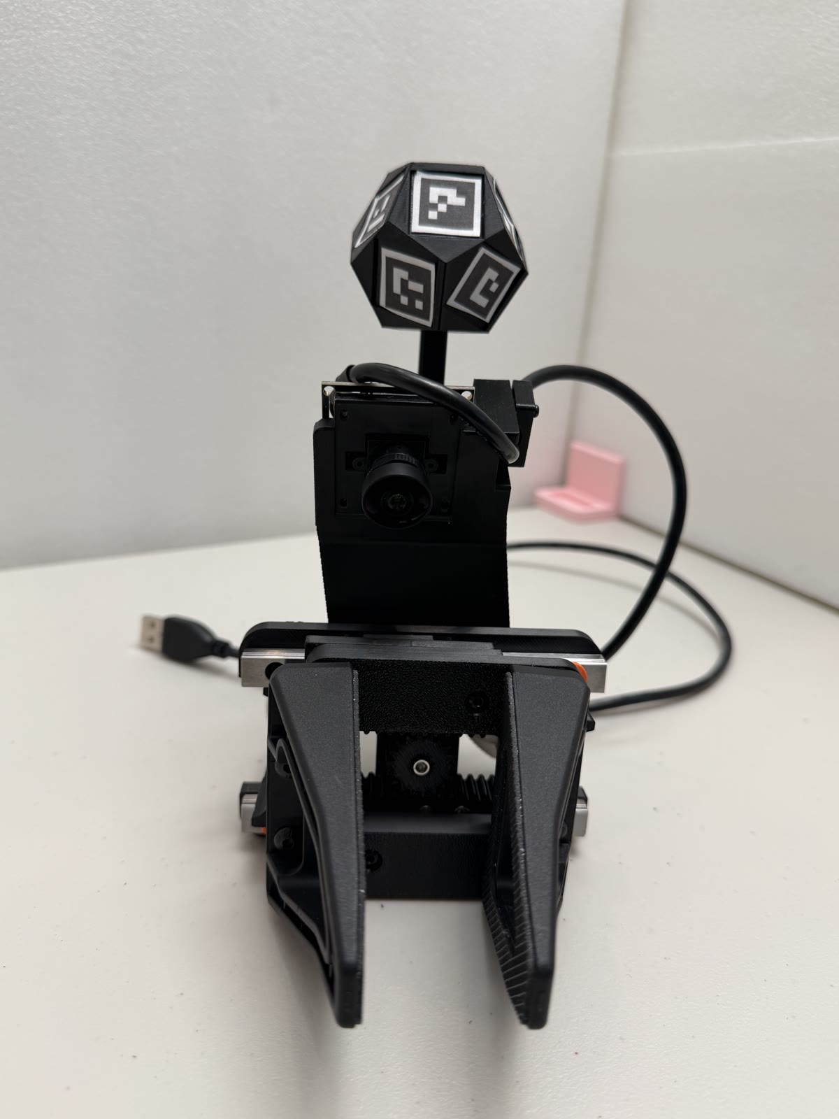 The assembled gripper with the dodecahedral marker ball on its wrist stalk.